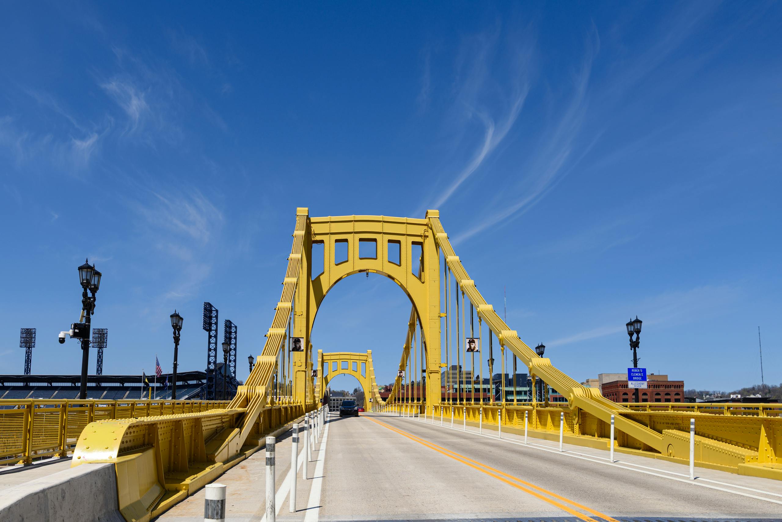 The Roberto Clemente Bridge stretches under a vibrant blue sky in Pittsburgh, PA.